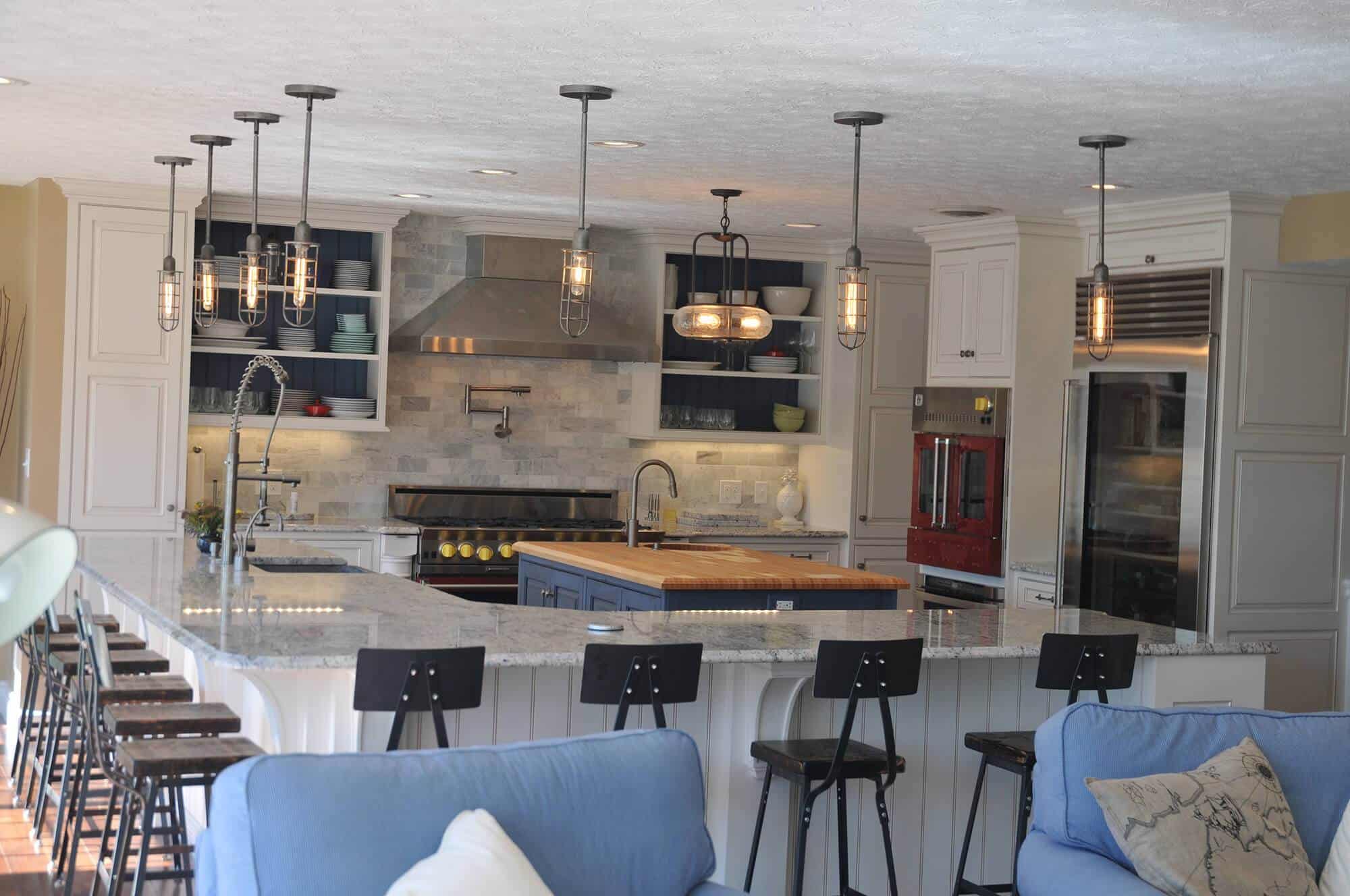 A kitchen with a large island and blue couches, perfect for kitchen remodeling.