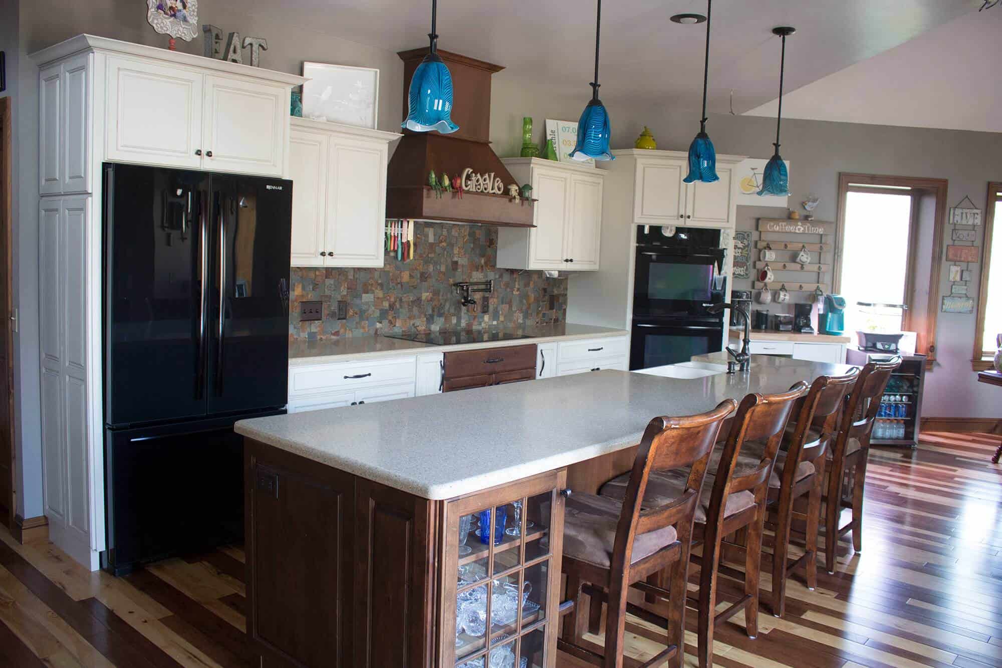 Remodeling a kitchen by adding a center island and bar stools.