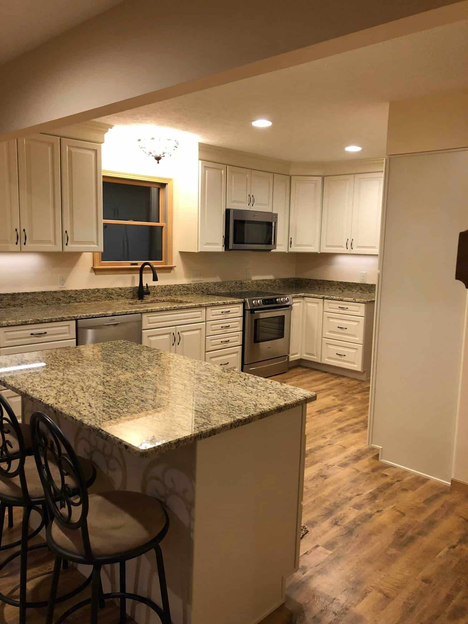 A kitchen remodeling with granite counter tops and stainless steel appliances.