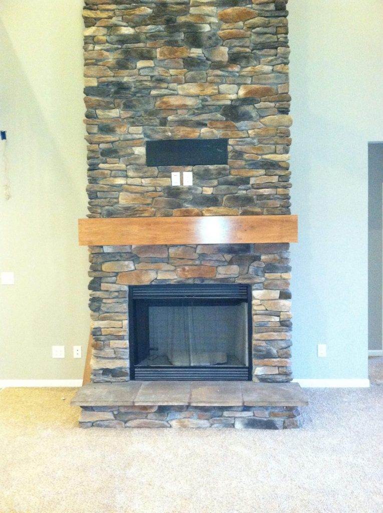 A stone fireplace in a new home building.