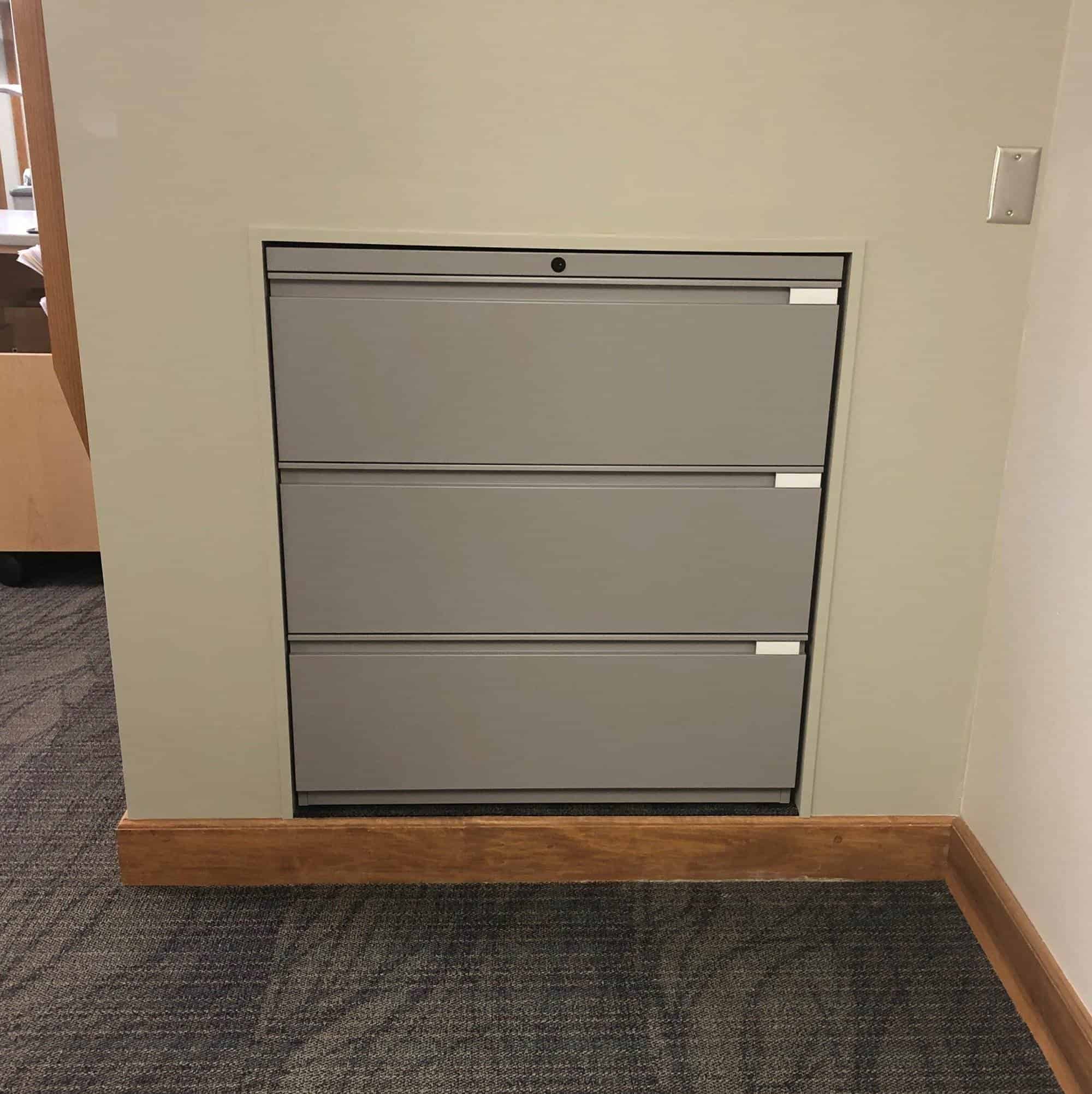 A gray filing cabinet in an office.